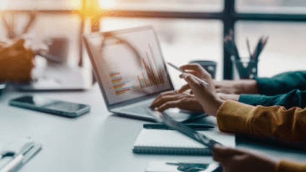 Small business owner reviewing website performance on laptop