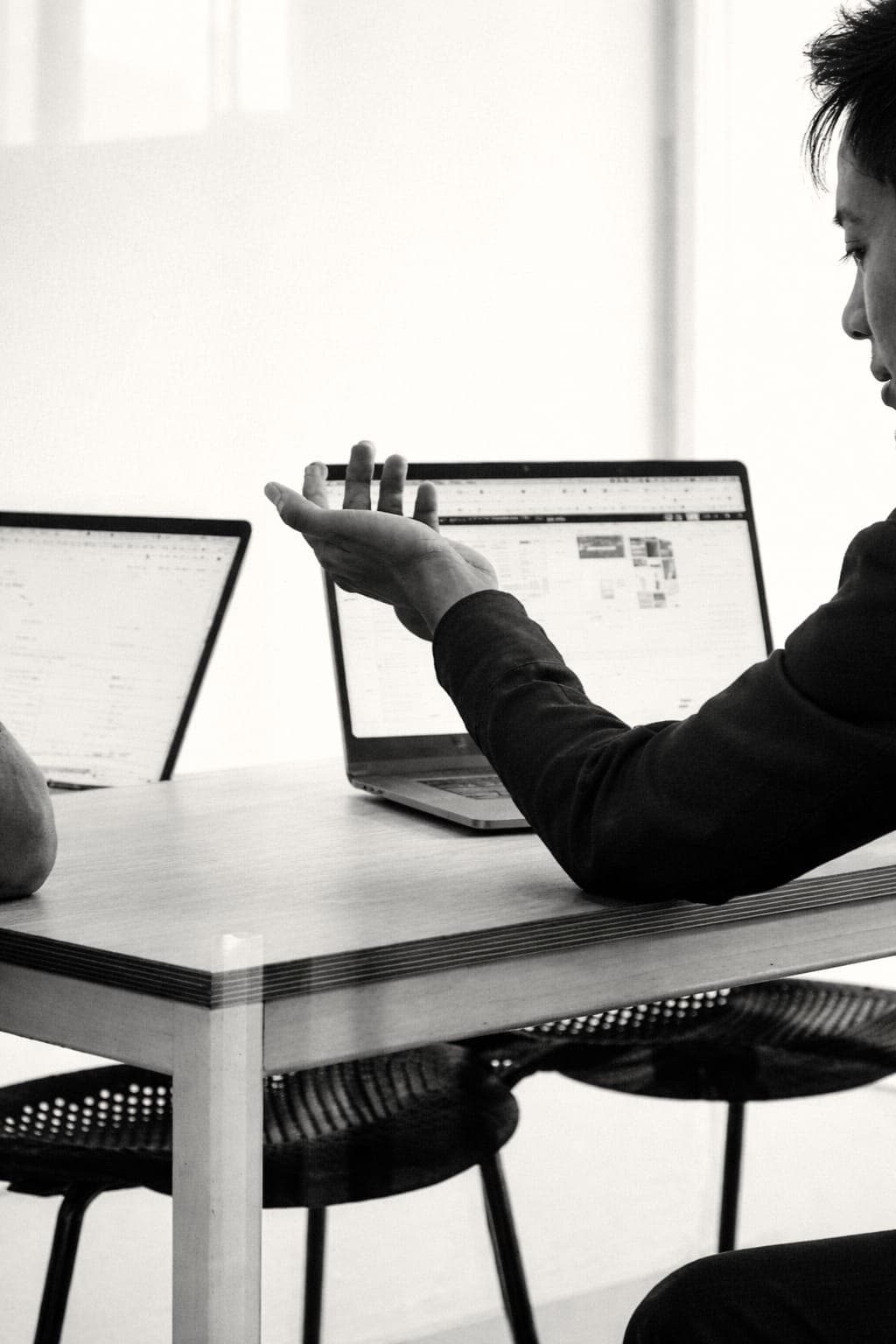 Designer reviewing a landing page layout across two screens